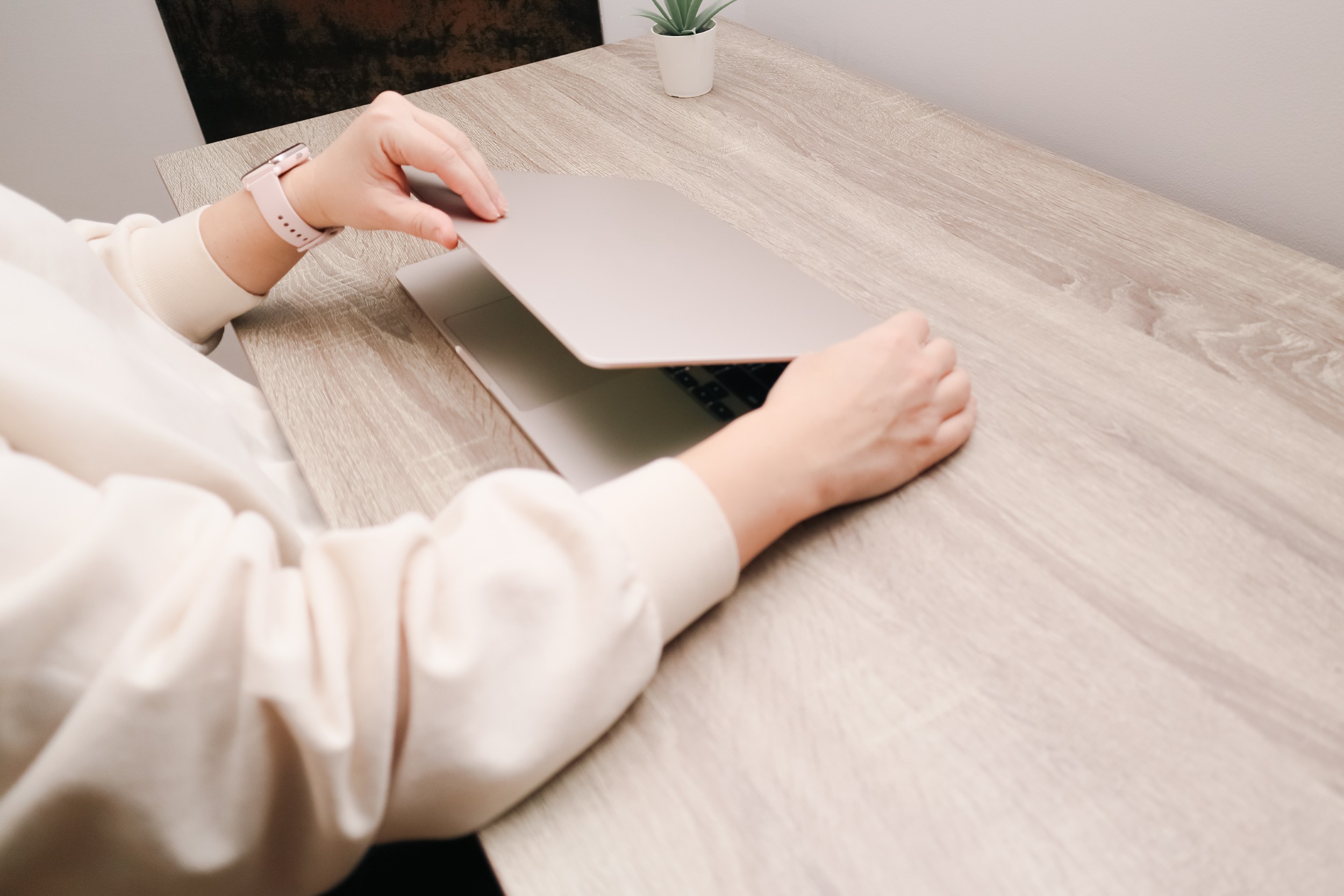 woman opening modern slim laptop wooden desk home office